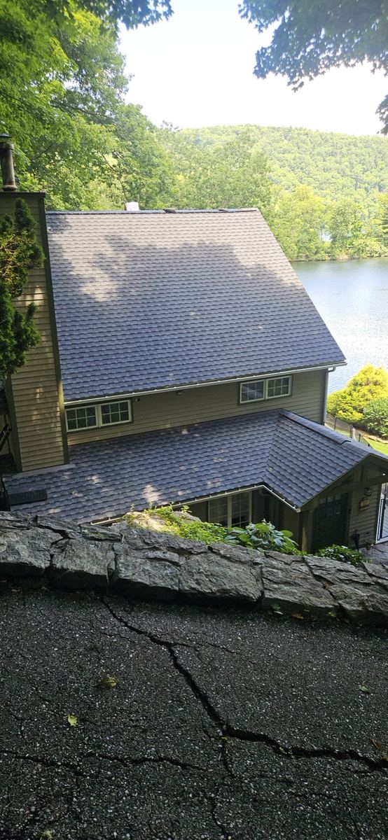 New architectural shingle roof on a hillside colonial