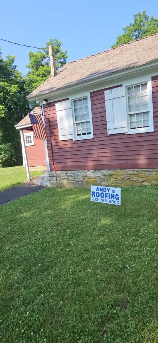 Historic Gaylordsville building with Andy's Roofing yard sign