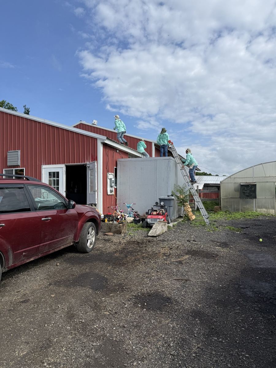 The crew at work on a barn roof