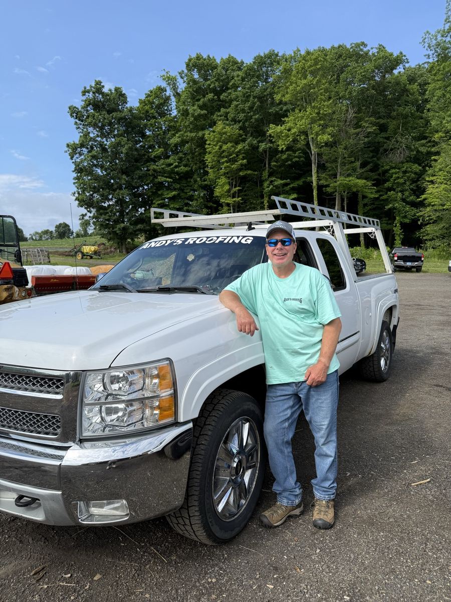 Crew member with an Andy's Roofing truck