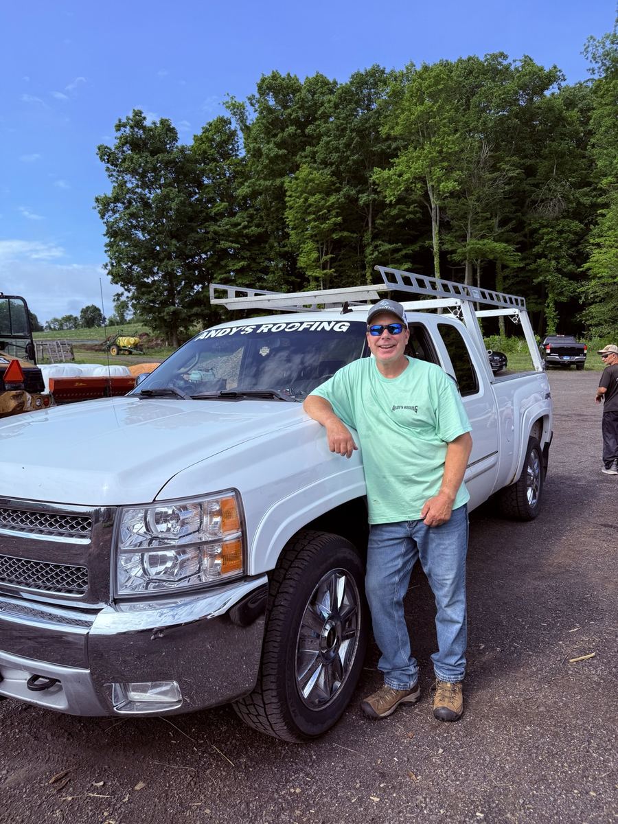 Andy's Roofing crew member with a company truck