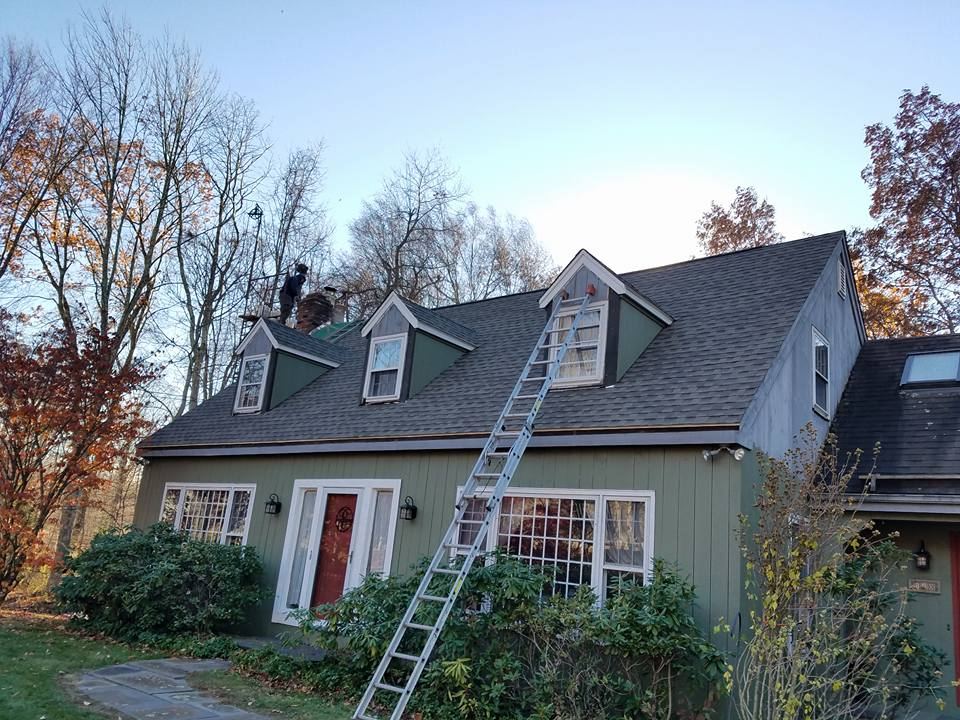 Late-season roof work with ladder to the ridge